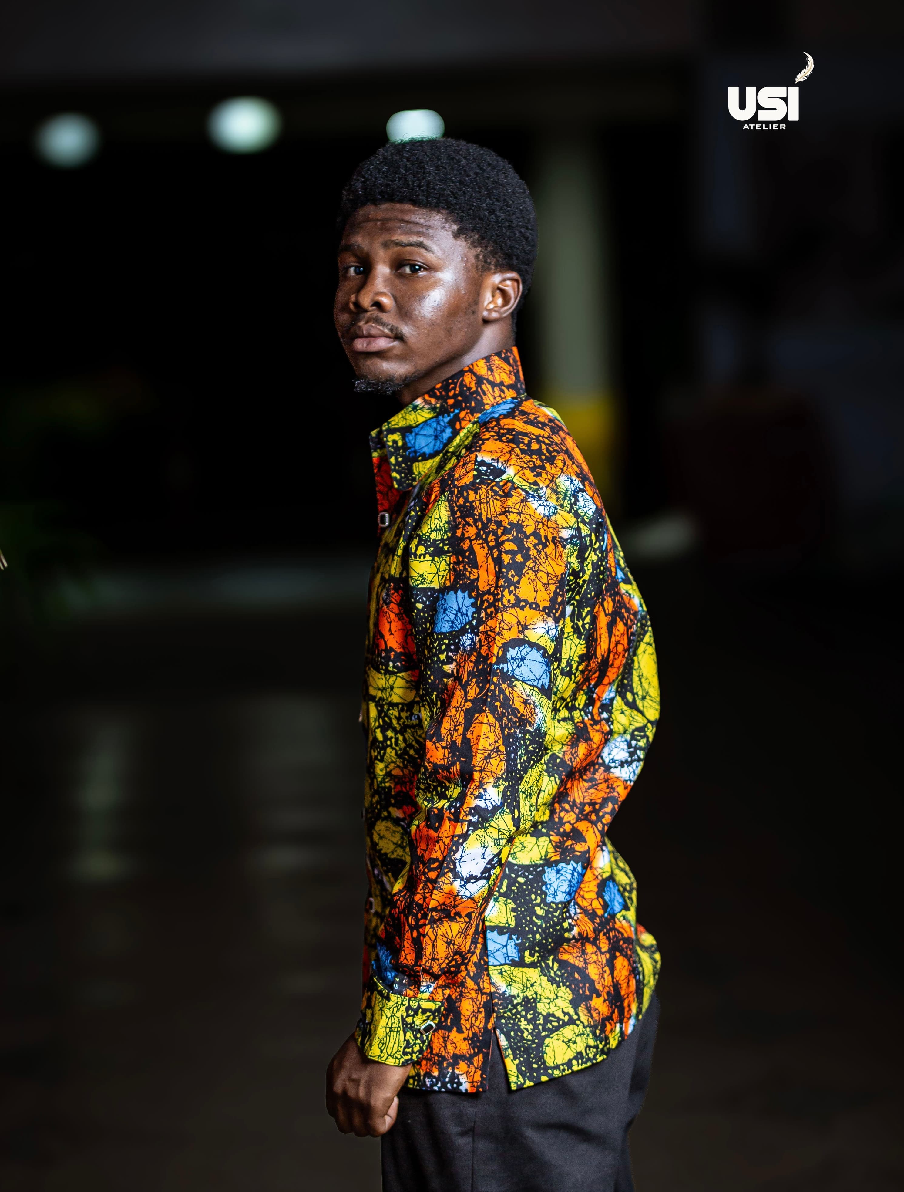 A model wearing a brightly coloured print long-sleeve shirt